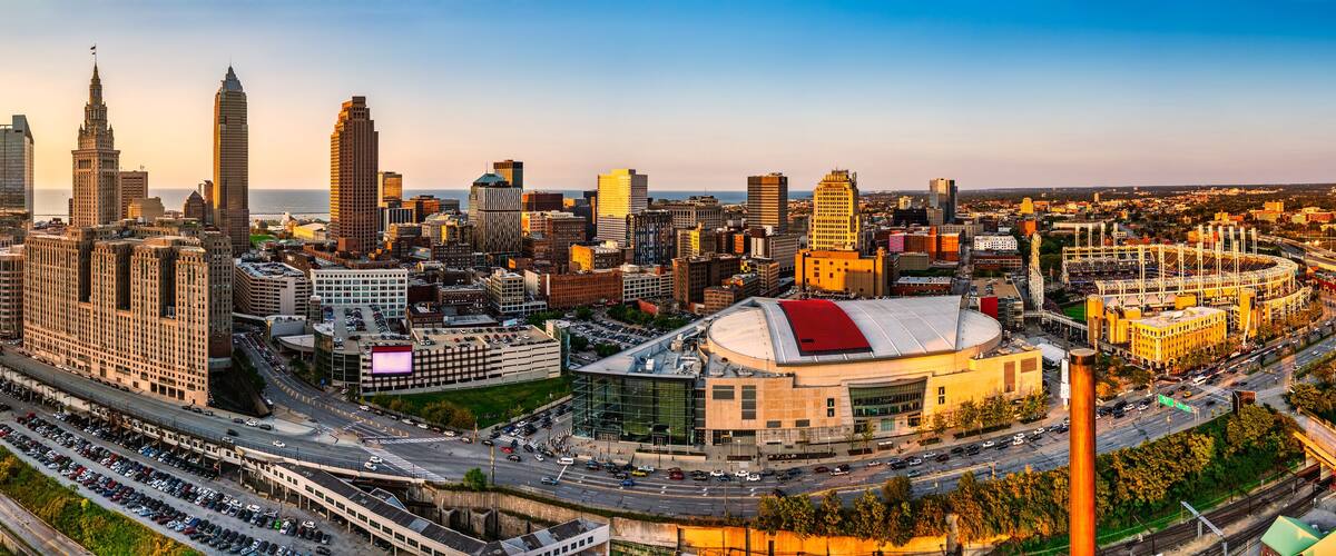 A cityscape with a prominent stadium, a river, and a bridge.