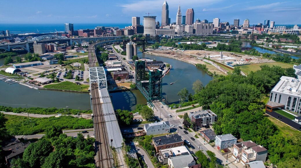 An aerial view of downtown Cleveland, Ohio with the Cuyahoga River in snaking through, including the rail lift brifge.