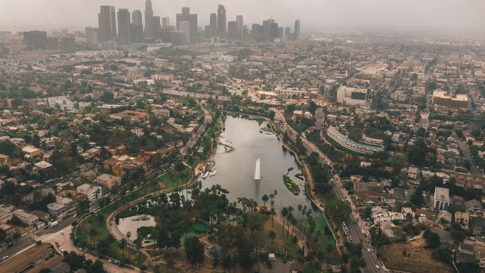 Echo Park in Los Angeles with View of Downtown Skyline and Foggy Polluted Smog Air in Big Urban City