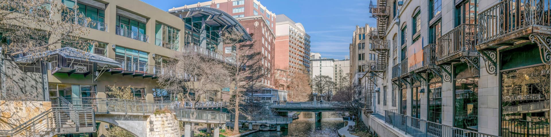 The San Antonio River Walk in Texas landscape with scenic canal under blue sky