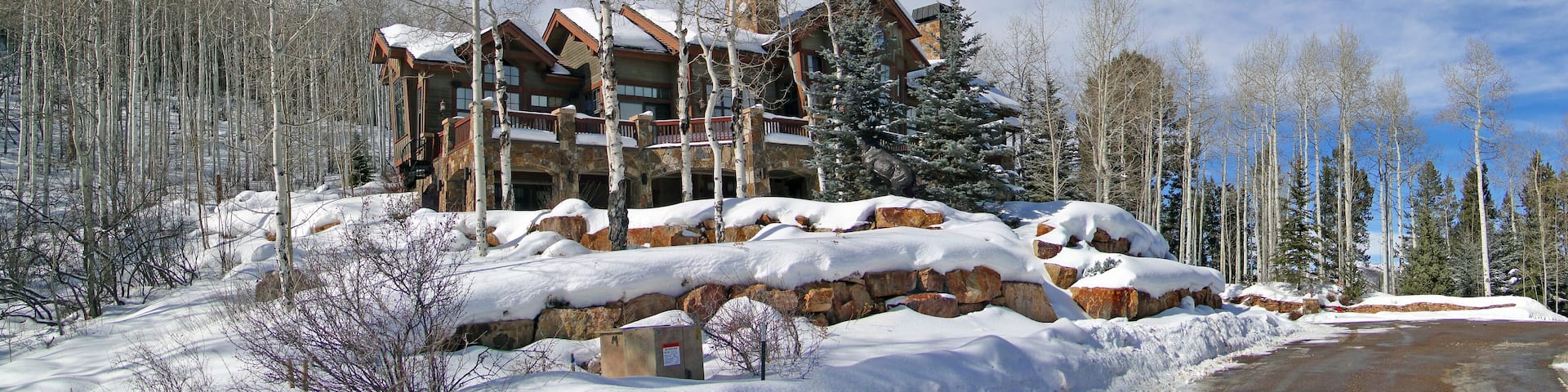 Large house in winter forest, above Vail Valley,Colorado