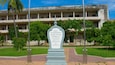 A historical building with a large inscription in front.