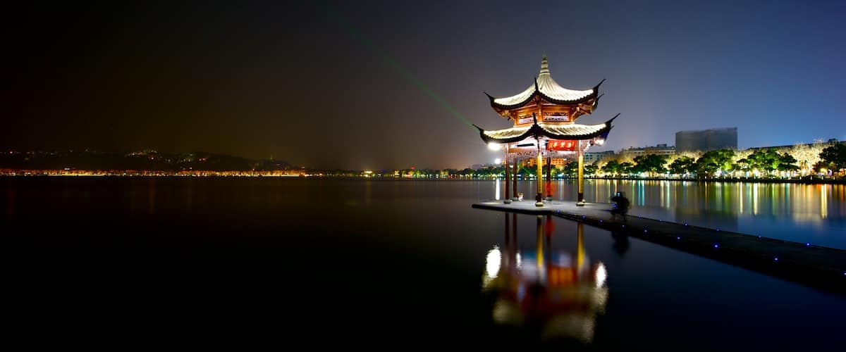 Hangzhou which includes a river or creek and night scenes