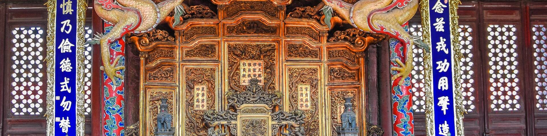 A traditional Chinese temple with ornate architecture, including golden dragons and intricate carvings.