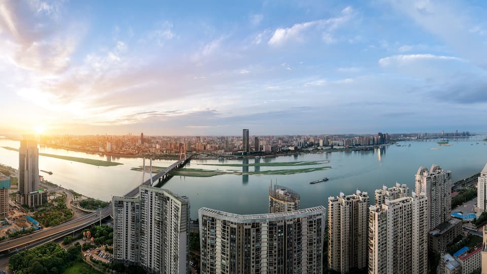 suspension bridge and modern residential district near haihe river in tianjin in blue cloud sky