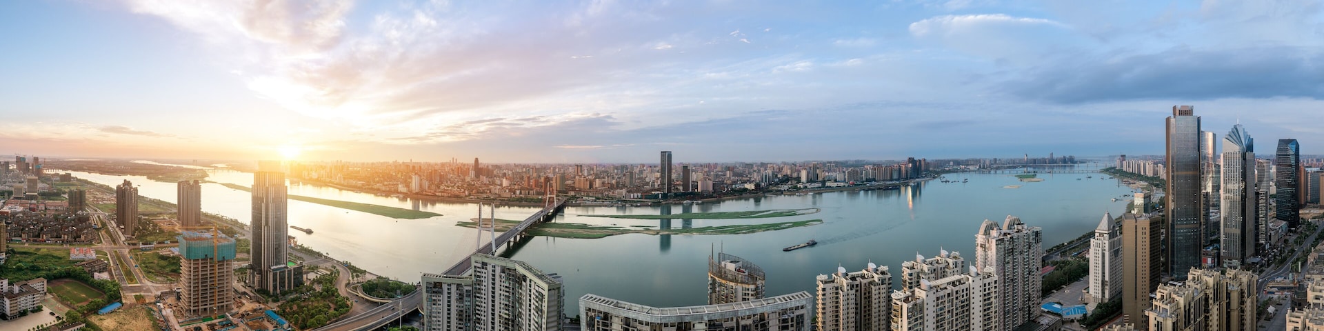 suspension bridge and modern residential district near haihe river in tianjin in blue cloud sky