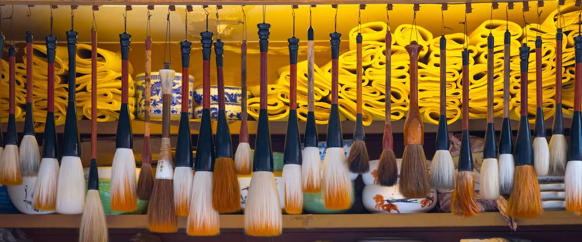 A display of traditional Chinese brushes and ceramics.