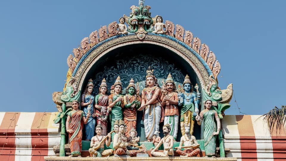 God Shiva weds Parvathi in the presence of Vishnu, Bramah, Naradha and other rishis. An excellent detailed sculpture made out of lime mortar at ancient Perur shiva temple in Coimbatore, Tamilnadu.