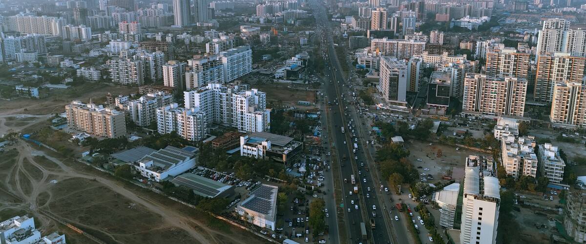 A densely populated urban area with high-rise residential buildings, a busy road, and scattered commercial buildings.