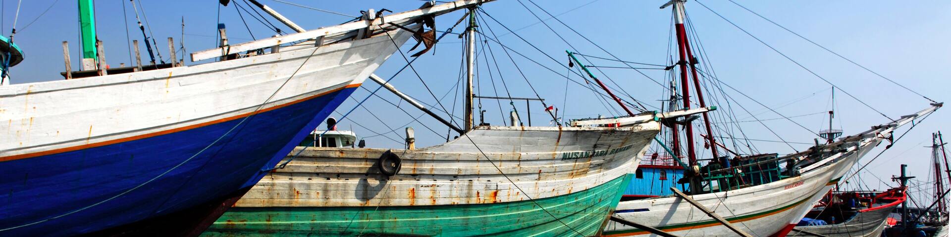 Several boats docked at a harbor.