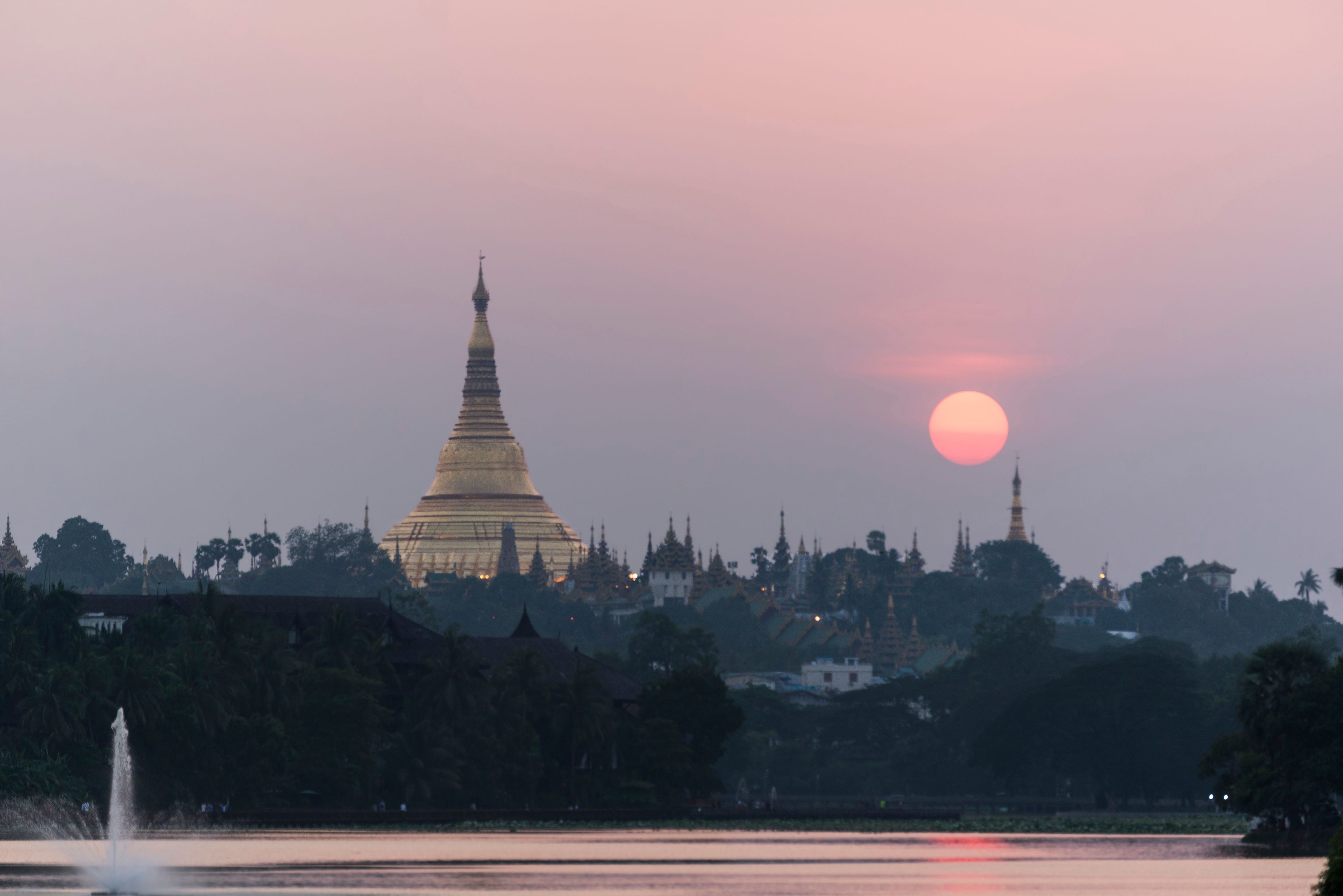 Shwedagon Pagoda with sunset sky from Kandawgyi Lake, Yangon, Myanmar