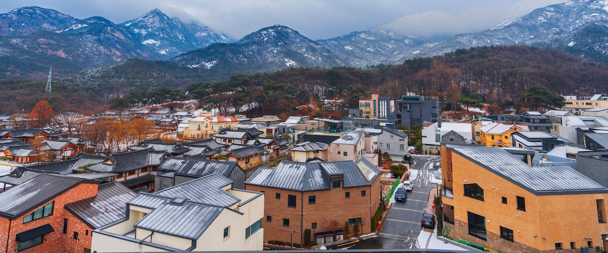 Seoul, South Korea Aerial and Winter View of Eunpyeong Hanok Village Houses. Tiled Roofs with Thin Snow Covering of Eunpyeong Hanok Village Houses in Seoul, South Korea