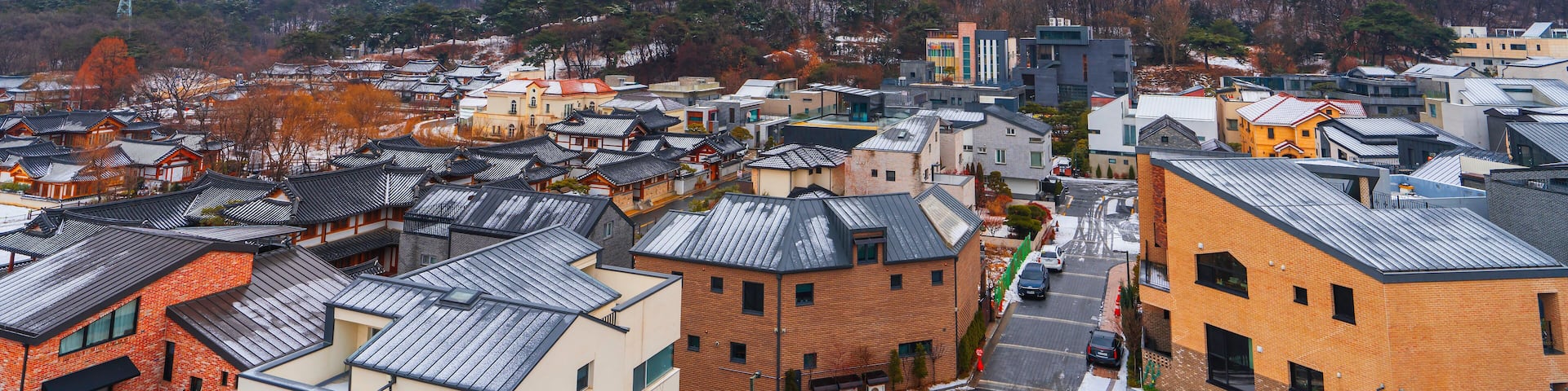 Seoul, South Korea Aerial and Winter View of Eunpyeong Hanok Village Houses. Tiled Roofs with Thin Snow Covering of Eunpyeong Hanok Village Houses in Seoul, South Korea