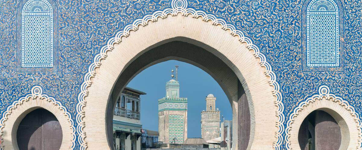 Fes, Morocco - ornate city gate of Fes el Bali, the old city, called Bab Bou Jeloud, a big blue gate in Fes, Morocco. It's like a grand entrance to the old part of the city.