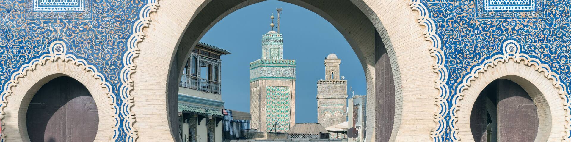 Fes, Morocco - ornate city gate of Fes el Bali, the old city, called Bab Bou Jeloud, a big blue gate in Fes, Morocco. It's like a grand entrance to the old part of the city.