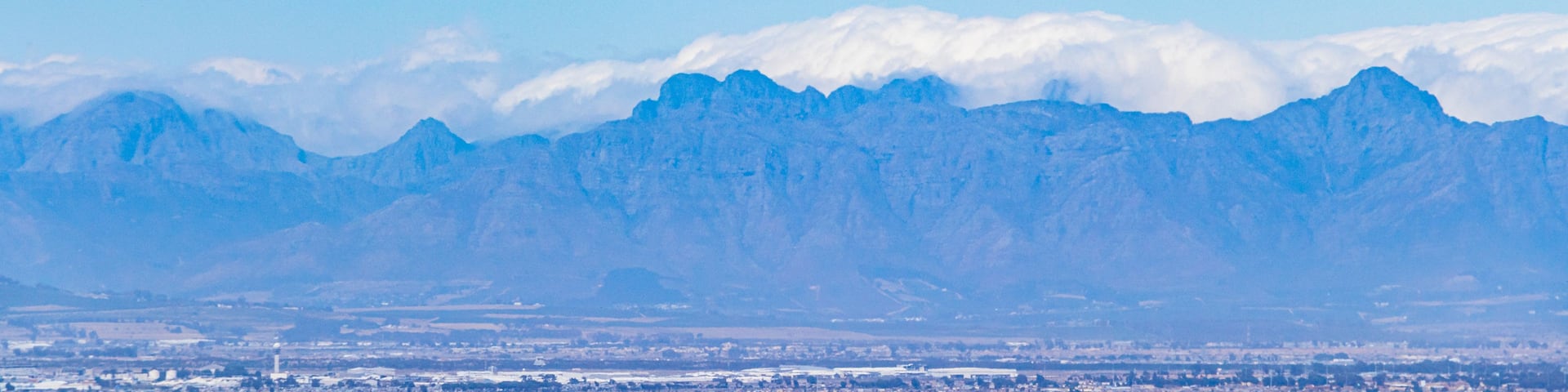 A mountain range with a city in the foreground.