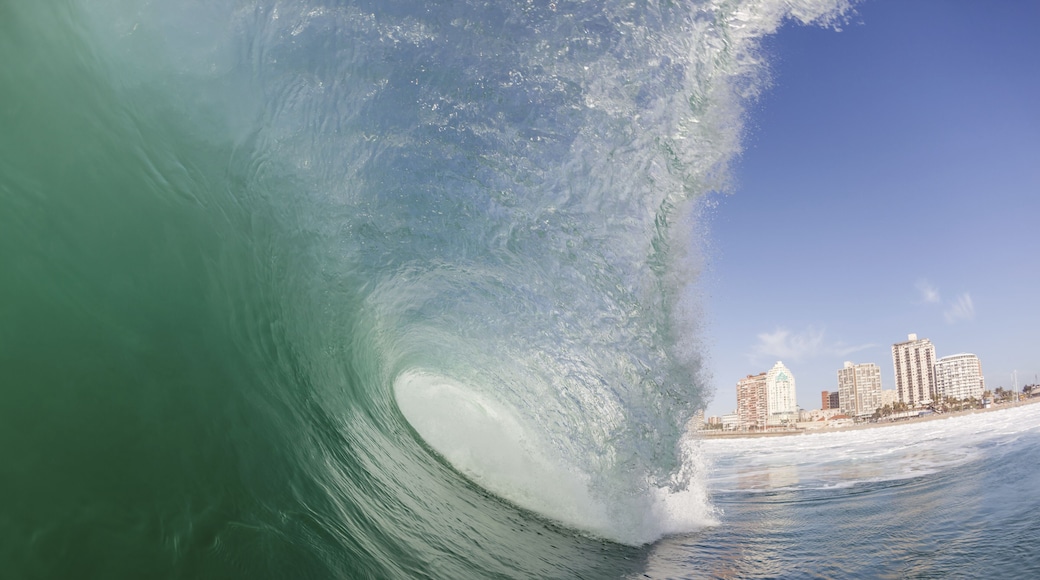 Clean ocean wave surging crashing towards shallow sandbars at surf city beaches of Durban
