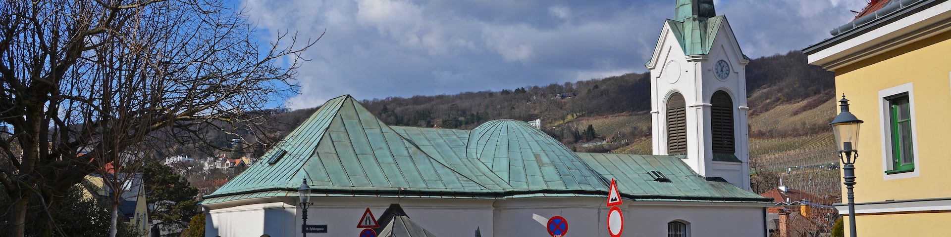 A church with a green roof and a tall steeple.