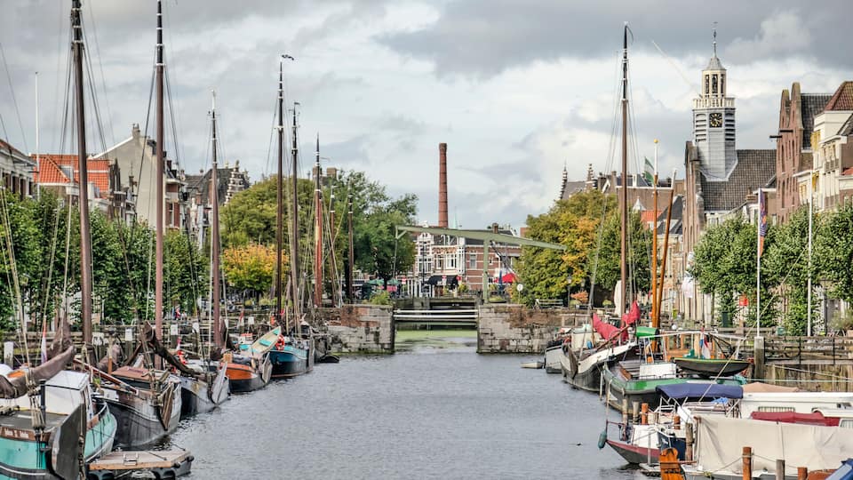 A canal lined with boats and historic buildings.