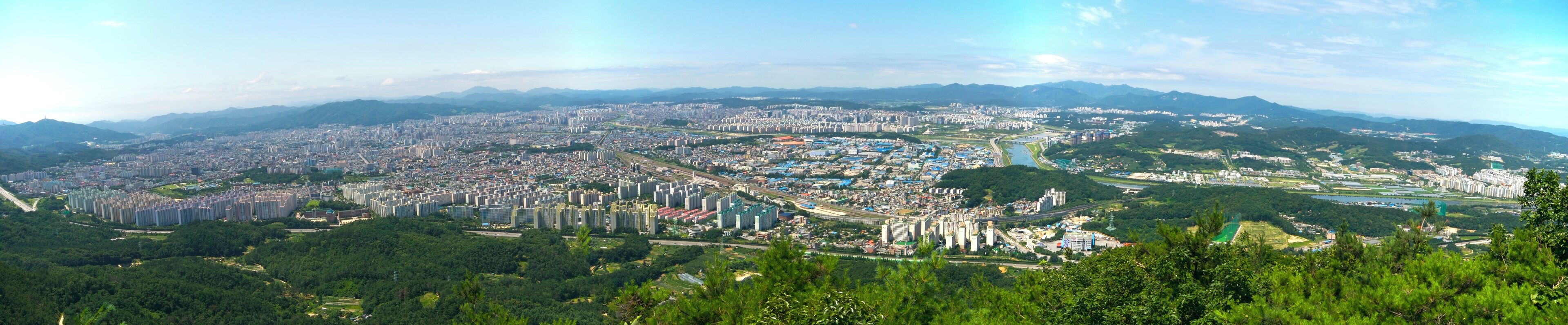 Cityscape of the metropolitan city of Daejeon, South Korea. This is a panorama of three photograhs stitched together using Hugin. The photographs were taken from Bonghwangjeong at Gyejoksan, a nearby mountain, using a 20mm focal length (crop factor 1.5) with aperture f/11.