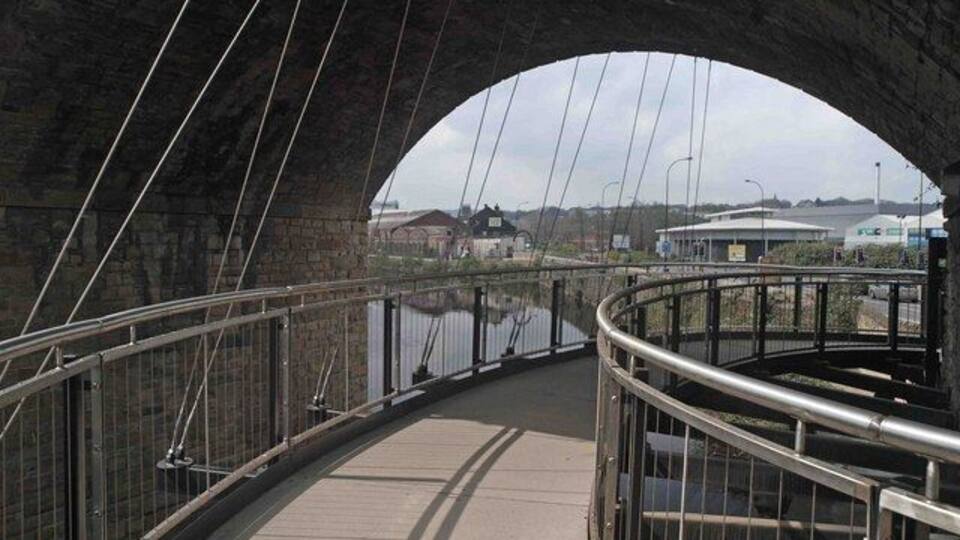 Suspended walkway under Norfolk bridge On the 5 weir's walk Sheffield.