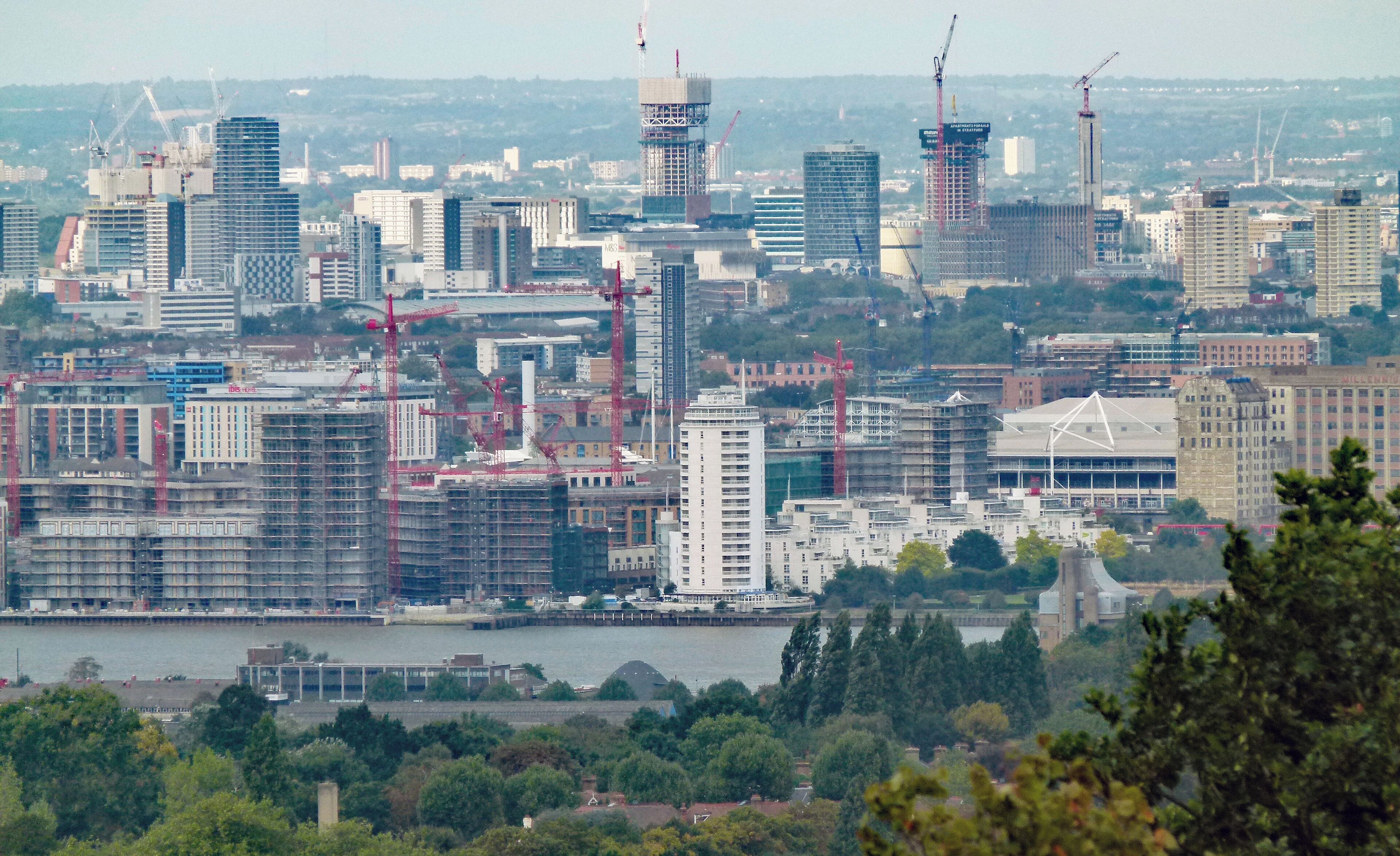 View towards the northwest from the top of Severndroog Castle, Shooters Hill, South east London, UK. Along the Thames: Royal Wharf, a residential development near Pontoon Dock.