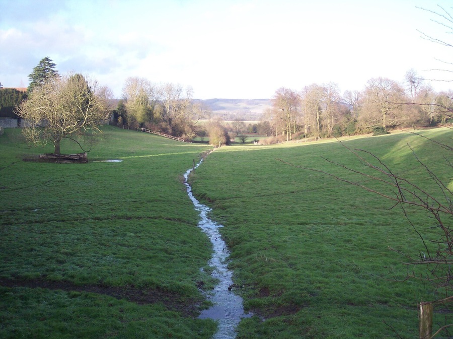 Stream near Sundridge Place Farm Seen from a bridleway from Church Road to Dryhill Farm on Dryhill Lane. The North Downs are in the background.