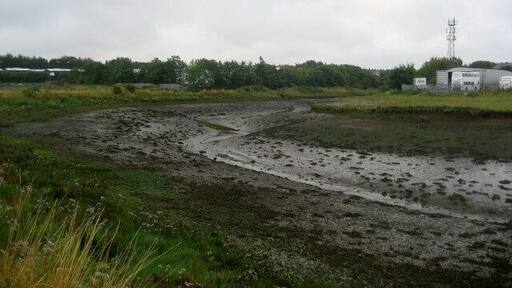 Creek in Cowpen New Town A creek with a somewhat pungent aroma just before it enters the Blyth Estuary, cuts into the Industrial Estate in Cowpen New Town. Walkers following the River Blyth are obliged to make a detour to navigate around this obstacle.