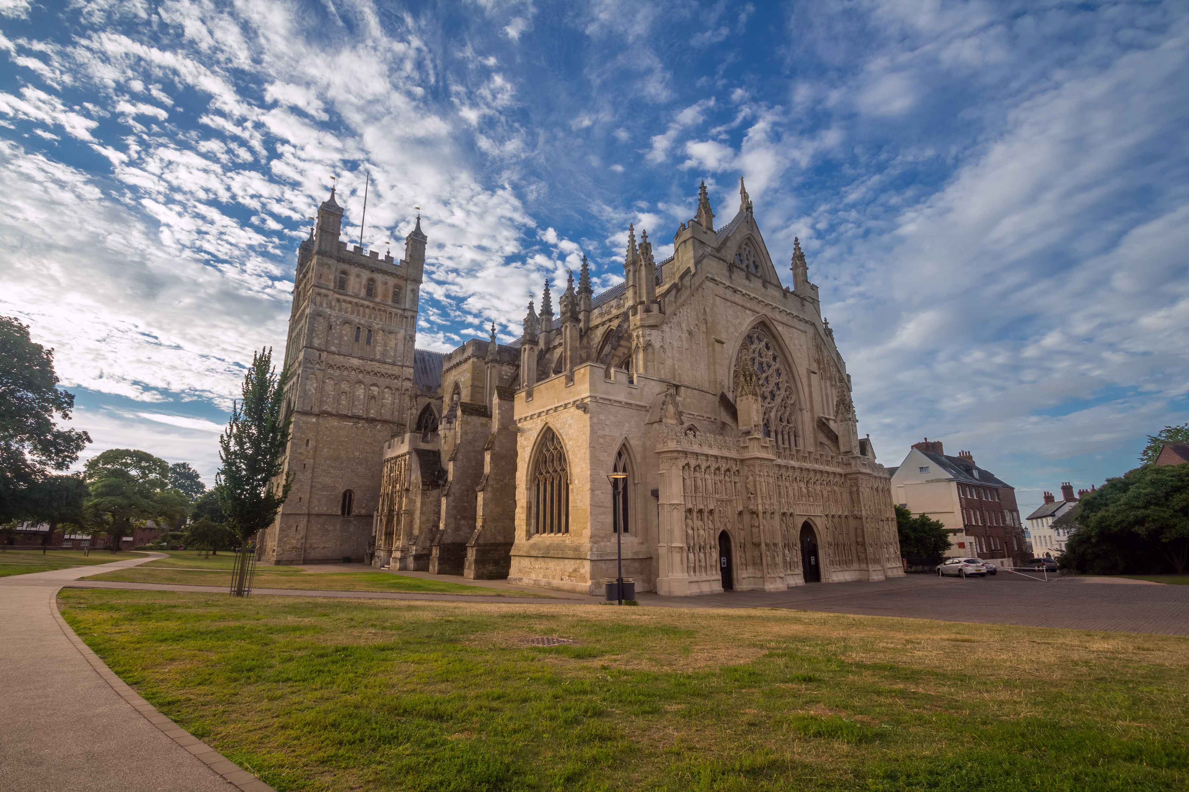 A historic cathedral with intricate Gothic architecture, a large rose window, and a tall spire.