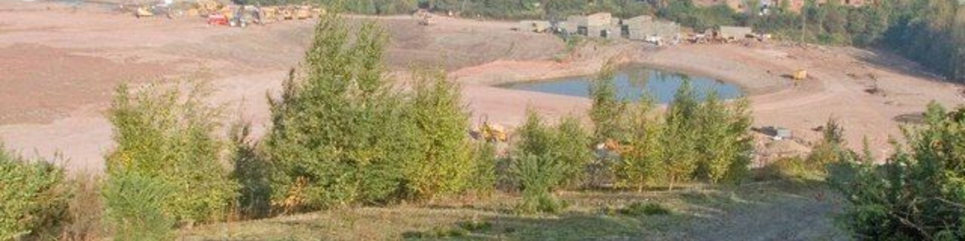 Clay pit being landscaped. This is 870823, photographed from the same position, three months later. The diminished lake seems likely to remain but I think the fish the Lilco (Lilleshall Company) anglers club used to pursue will have gone.