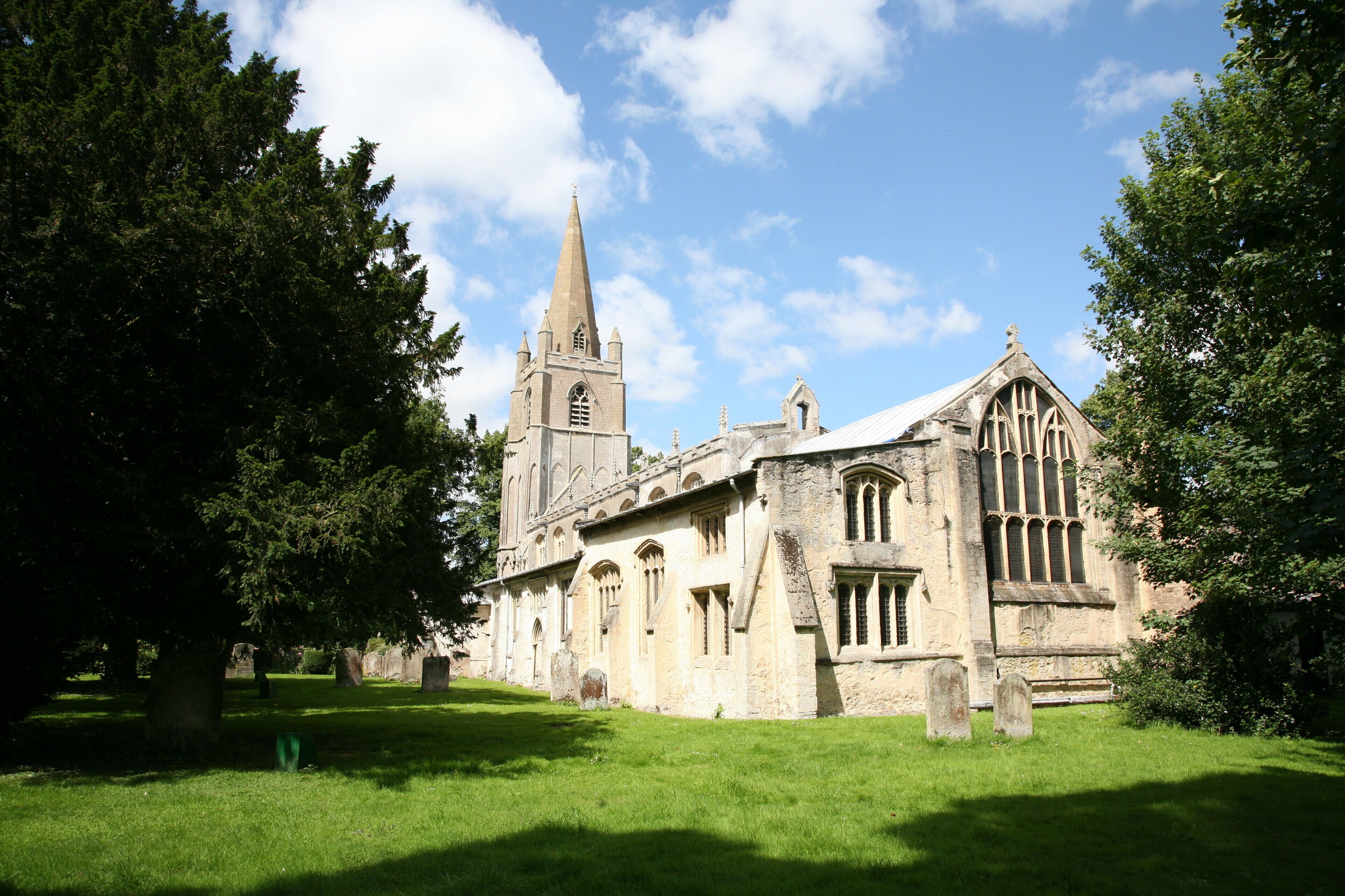 A historic church with a tall spire and arched windows.
