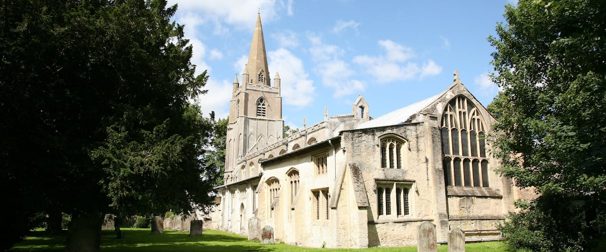 A historic church with a tall spire and arched windows.