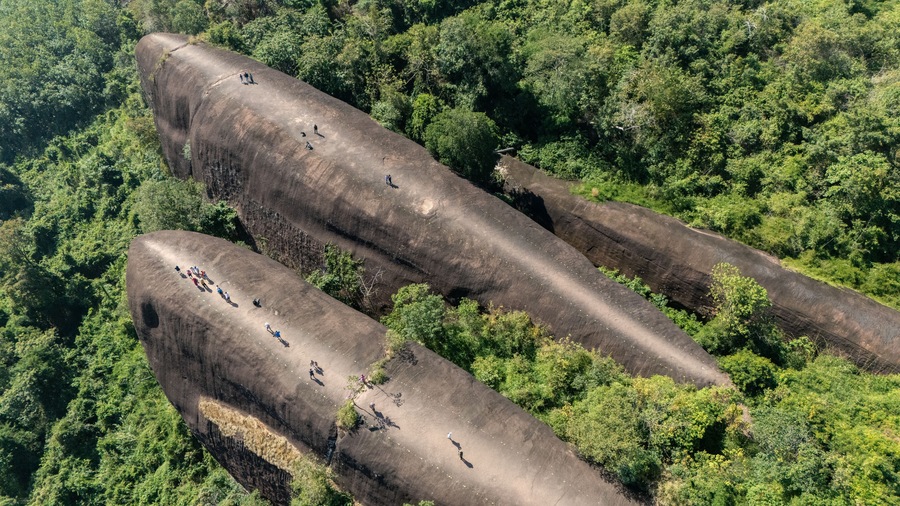 Aerial view of an iconic Three Whales Rock (in Thai called Hin Sam Wan) a 75-million-year-old rock formation protruding out of a mountain in Phou Sing, Bueng Kan Province, Thailand.