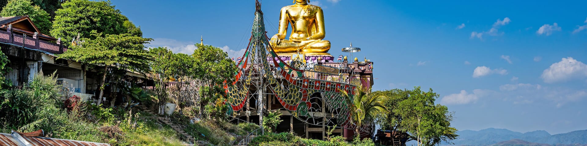 Ban Sop Ruak, Thailand - The Golden Triangle Buddha (Phra Chiang Saen Si Phaendin) on a decorated boat overlooking the Mekong River.