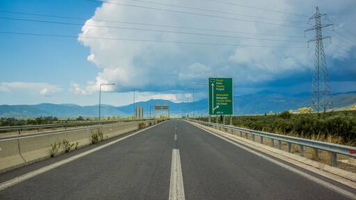 European Union highway road in Greece symmetry photography inscription about Greece cities Patra, Pyrgos and Meligalas on pointer