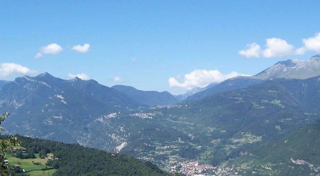 A mountainous landscape with a valley and a small town.