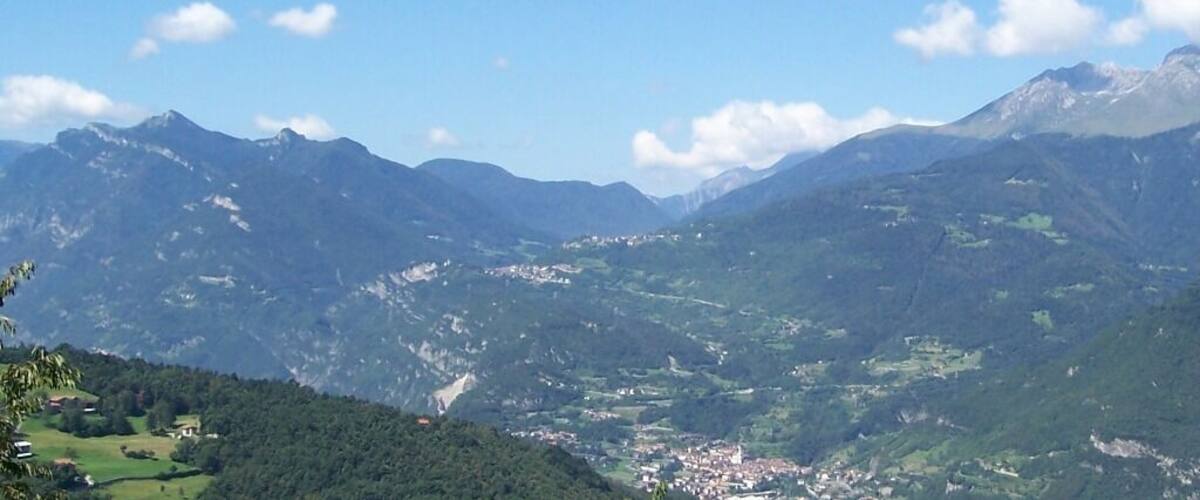 A mountainous landscape with a valley and a small town.
