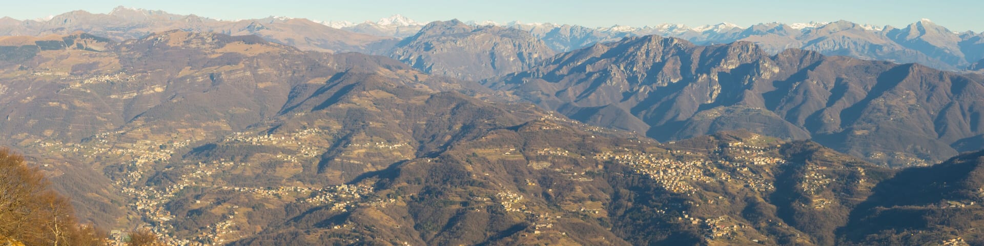 Great landscape with fantastic blue sky on the Orobie Alps and Padana plain a dry winter season without snow. Panorama from Linzone Mountain, Bergamo, Italy.