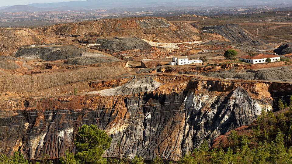 A mining area with rugged terrain and sparse vegetation.