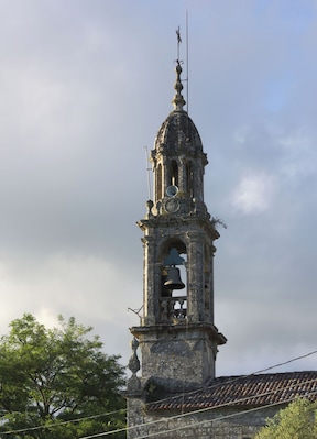 A historic bell tower with a dome and a bell.