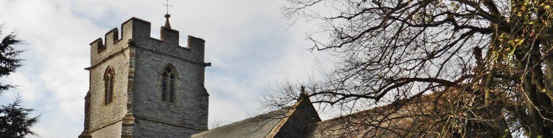 A historic church with a tall tower and arched windows.