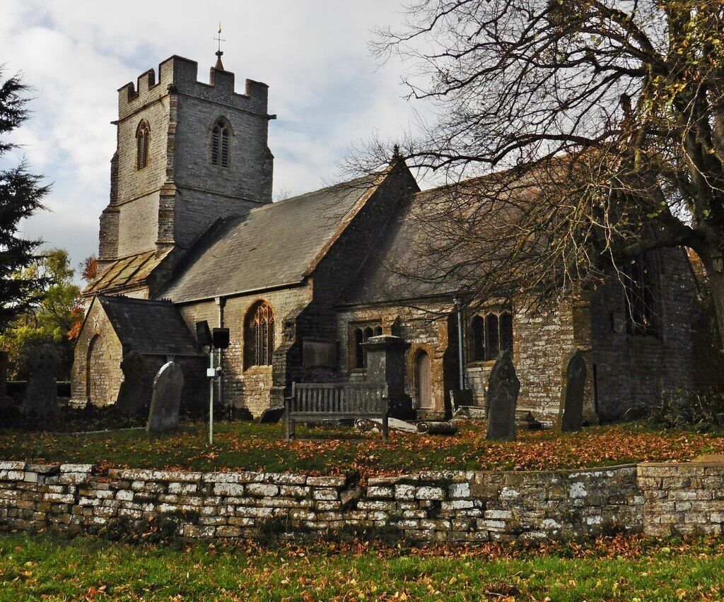 A historic church with a tall tower and arched windows.