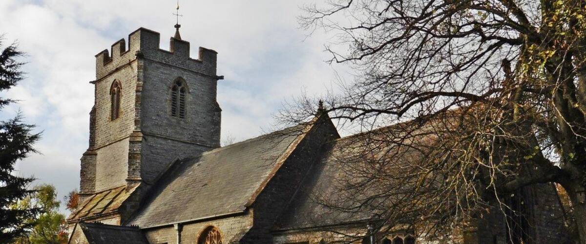 A historic church with a tall tower and arched windows.