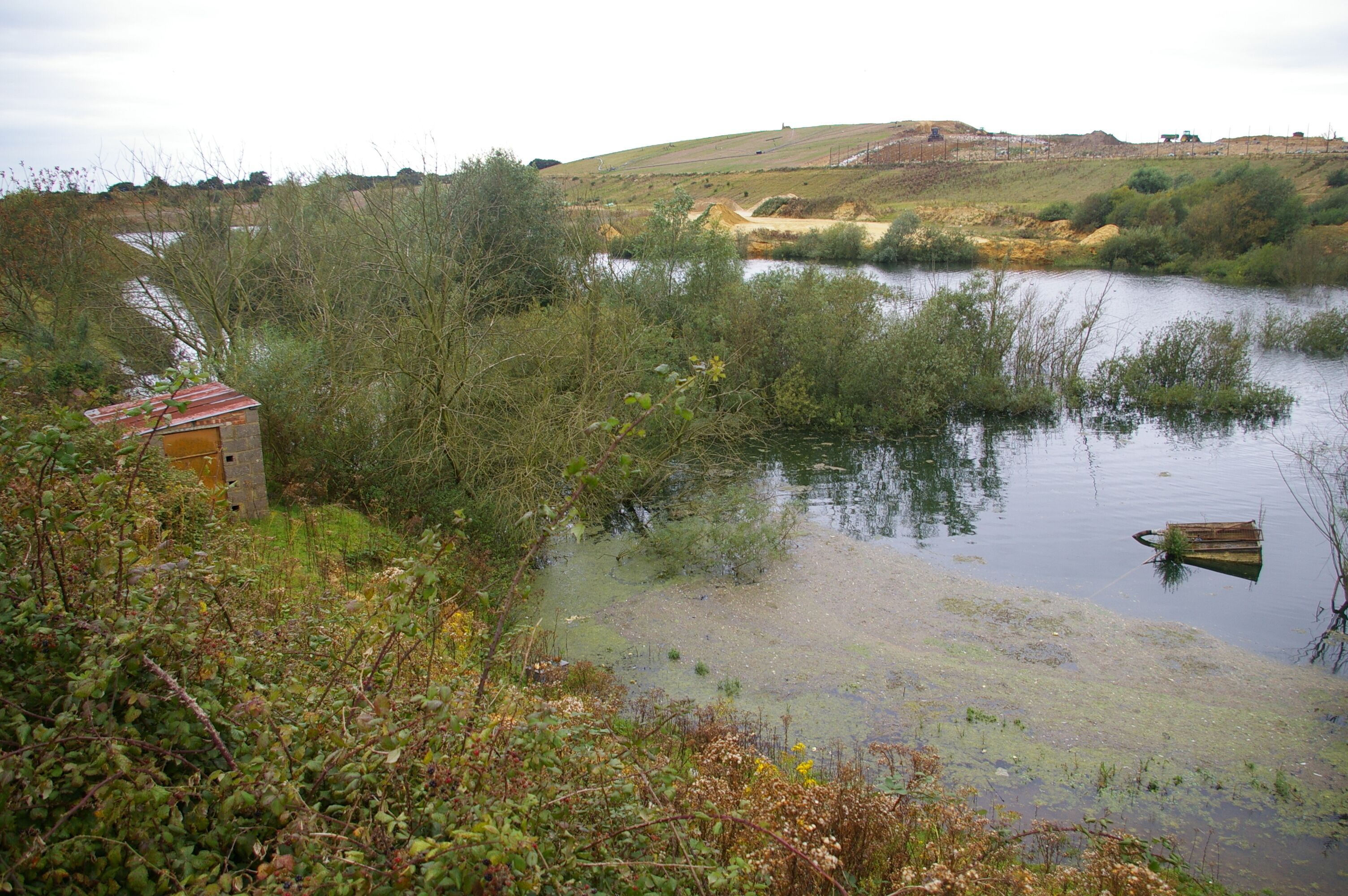 Flooded sand pit Not the pleasantest of places. On the far side of the pit is a rubbish dump.