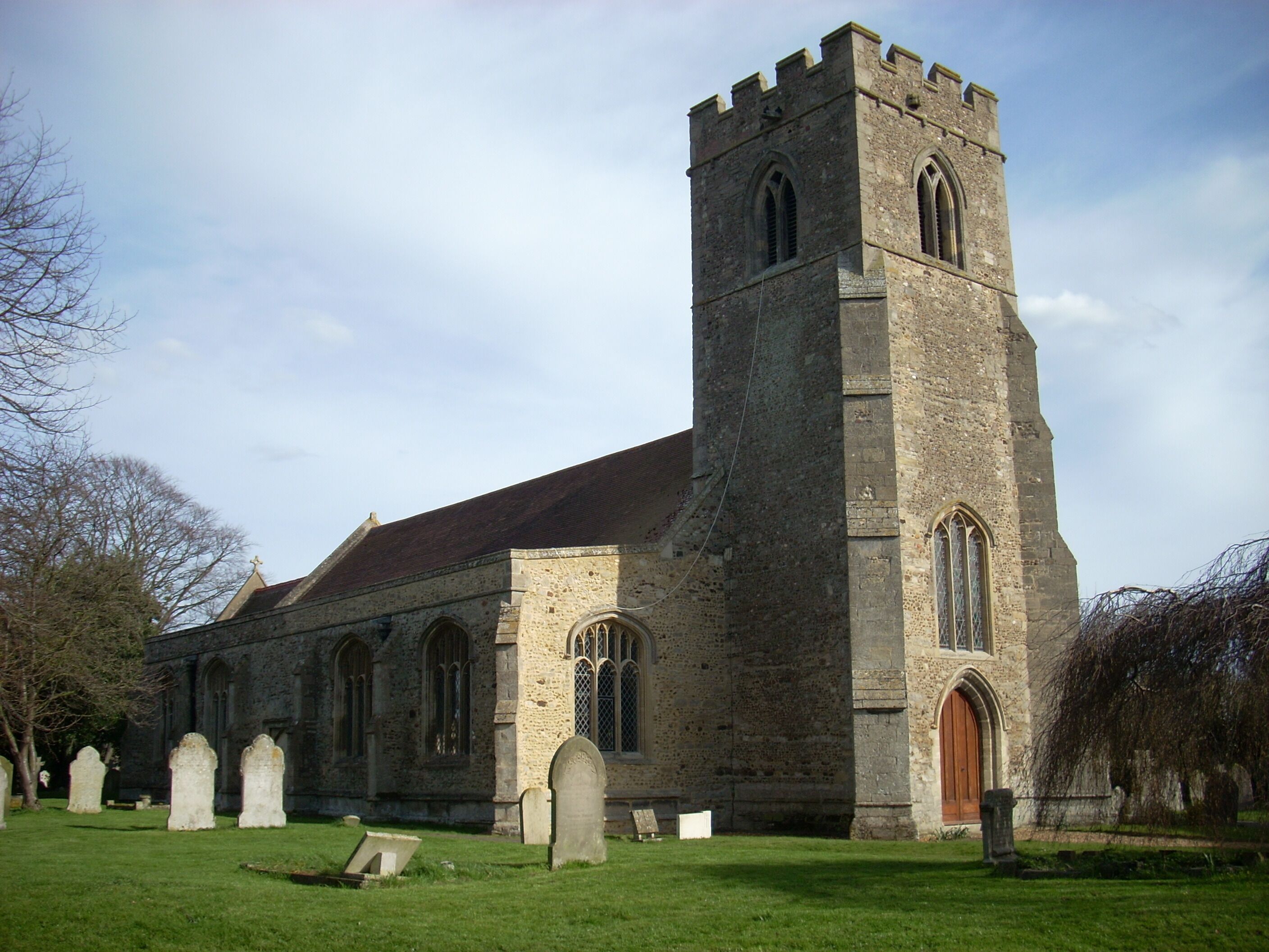 A historic church with a tall tower and arched windows.