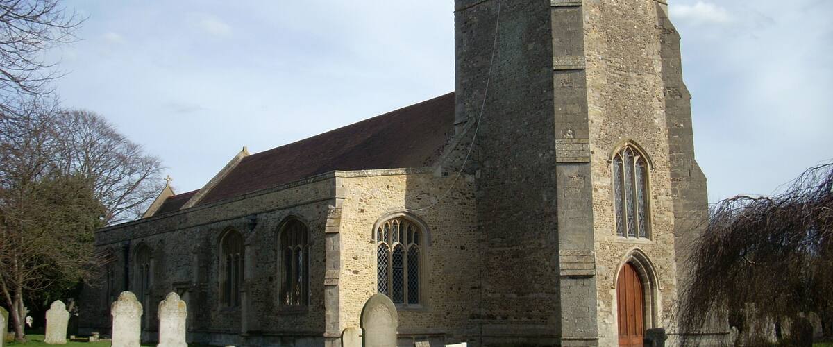 A historic church with a tall tower and arched windows.