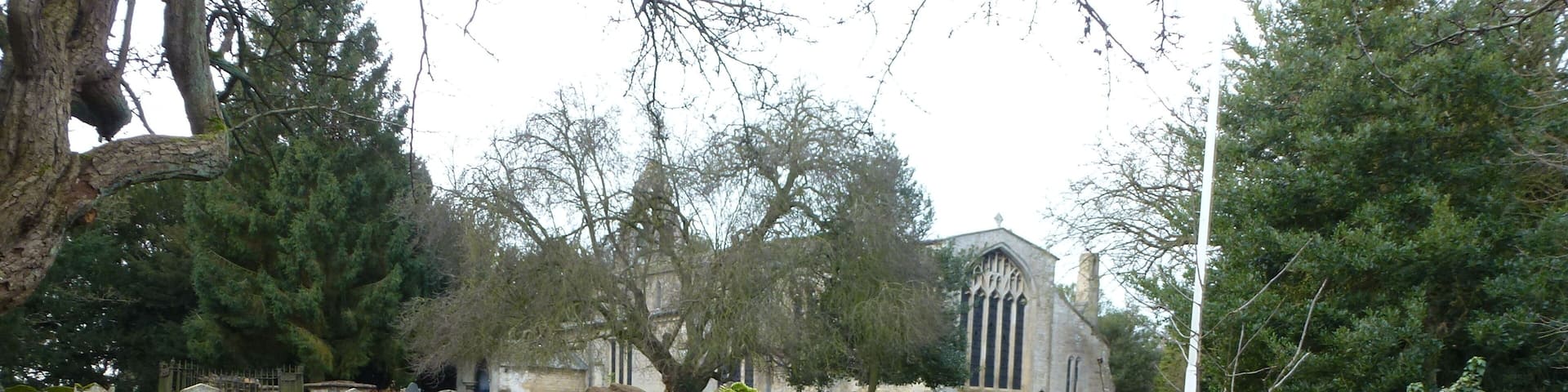 A cemetery with moss-covered stone walls and gravestones.