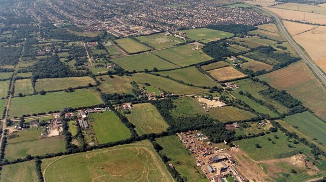 Aerial view of New Thundersley and Plotlands from the north-east. This image is taken from a point to the west of 1559136, and shows more land to the north of that (bottom of the picture). To the bottom right is Lychgate Farm. The tracks in the field to the left of this were probably made by motor cycles. (At the time many of these fields were used by unlicensed motor-bikes.) The A130 runs along the right edge, and along the left edge is Coniston Road.