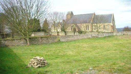 View northwest across a field at Strixton, Northamptonshire, to the parish church of St Romwald. In 1973 The Buildings of England recorded the patron saint as John the Baptist. Its dedicatee now, however, is Rumwold of Buckingham.