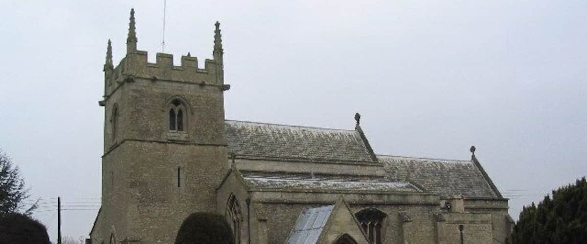 A historic church with a prominent tower and arched windows.